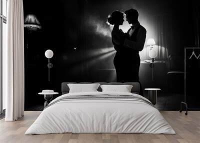 A romantic silhouette of a couple dancing in a softly lit, smoky environment. Wall mural