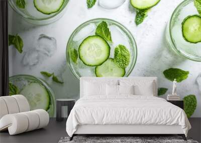 A row of four glasses of cucumber water with mint leaves floating on top Wall mural