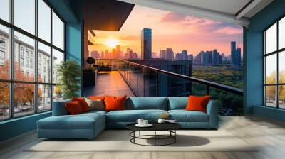 A scenic sunset view from a modern balcony overlooking a city skyline and green landscape. Wall mural