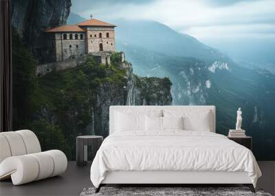 A scenic view of a monastery perched on a cliff amidst misty mountains. Wall mural