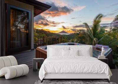 A serene hot tub overlooking a tropical sunset and lush landscape. Wall mural