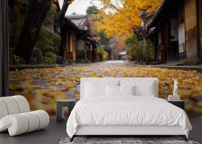 A serene pathway lined with vibrant autumn leaves in a tranquil setting. Wall mural