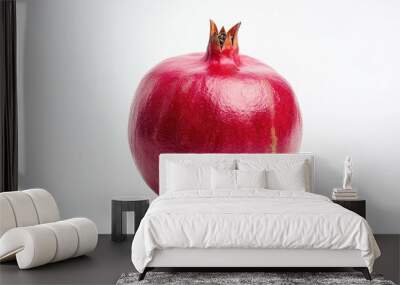 A single ripe pomegranate on a white background, showcasing its vibrant color and texture. Wall mural