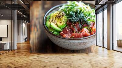 A vibrant bowl of fresh poke featuring tuna, avocado, seaweed, and sesame seeds. Wall mural