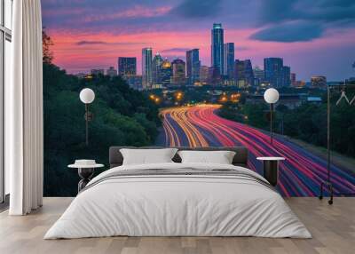 A vibrant city skyline at sunset with light trails from traffic on a highway. Wall mural