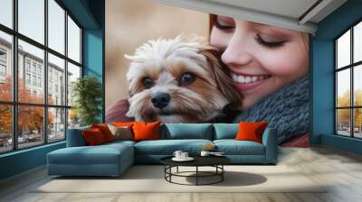 A woman joyfully embraces her small dog, showcasing a moment of affection and companionship. Wall mural