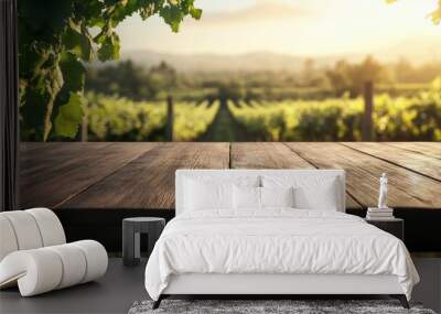 A wooden table in a vineyard at sunset, showcasing lush grapevines and scenic hills. Wall mural