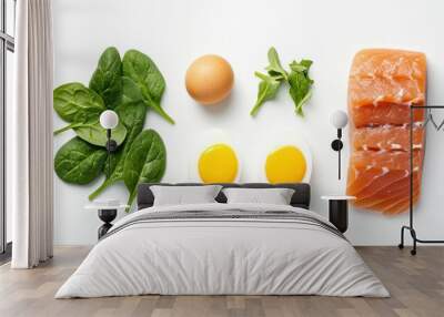 An arrangement of spinach, an egg, herbs, boiled eggs, and salmon, highlighting healthy eating. Wall mural