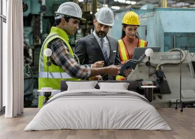 Two young men and women engineers And management consultant for auto parts design at an auto parts factory in Thailand. Wall mural