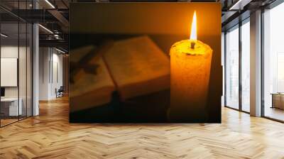 Candle on wooden table with the Bible and cross in the night. worship prayer and bible study concept. Wall mural