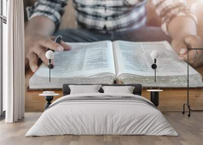 Close up Bible or book with a man reading at home. christian concept. Wall mural