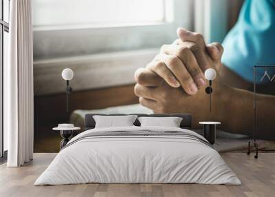 Close up hands of man praying with Bible Wall mural