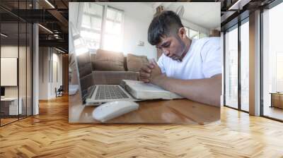 Man praying on bible with computer laptop, Online church in home, Home church during quarantine coronavirus Covid-19, Religion concept Wall mural