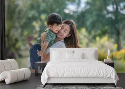 Asian family having fun mother and her son playing in the park together Wall mural