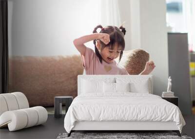 Happy Asian child having fun and dancing in a room Wall mural