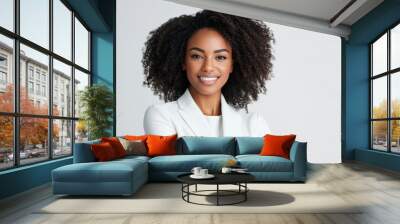 A confident African American businesswoman in a white suit smiles warmly with arms crossed, standing against a neutral background, perfect for corporate or business settings. Wall mural