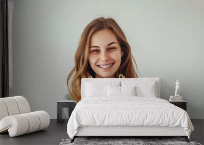 A smiling young caucasian woman in a casual attire holds a gold trophy, her eyes shining with pride. The image captures the essence of victory and the rewards of dedication. Wall mural