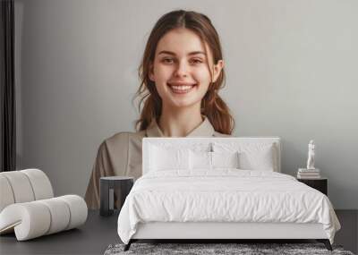 A smiling young caucasian woman in a casual attire holds a gold trophy, her eyes shining with pride. The image captures the essence of victory and the rewards of dedication. Wall mural