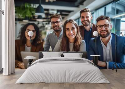 A team of professionals, both men and women in a modern office, showcasing their enthusiasm and camaraderie as they pose for a group photo while working on laptops. generative AI. Wall mural