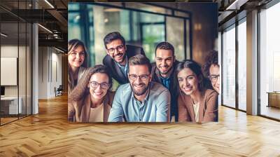 A team of professionals, both men and women in a modern office, showcasing their enthusiasm and camaraderie as they pose for a group photo while working on laptops. generative AI. Wall mural