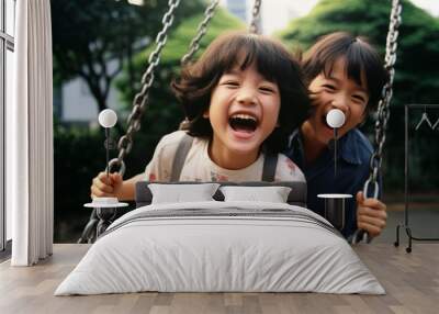 An adorable Asian young girl smiling on a swing enjoys playing in a park below the bright morning sunlight with the other children playing in the same park. Generative AI. Wall mural