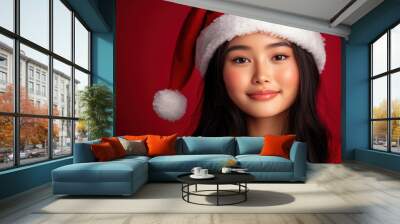 An Asian woman in a red attire stands against a matching red background, exuding warmth and friendliness, perfect for red-themed marketing campaigns. Wall mural