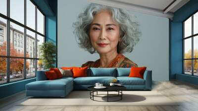 An elegant Asian woman in traditional attire stands confidently, exuding grace and timeless beauty. Wall mural