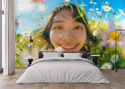 In a flower-filled garden, an attractive Asian woman with a captivating and charming face is captured laughing joyfully in the morning light. Wall mural