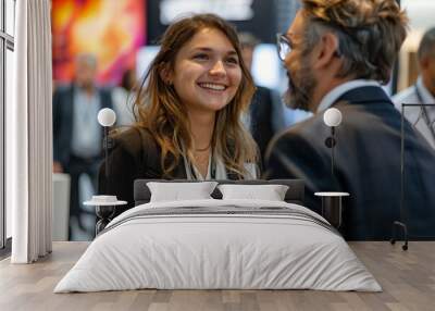 individuals in business casual attire as they laugh and chat together at an exhibition booth after the fair concludes captures the genuine connection and happiness shared among friends. Wall mural