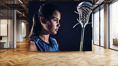 Lacrosse player woman cradling the ball with skill and agility, her serious expression reflecting her dedication to the fast-paced game, captured in studio light with cinematic color grading. Wall mural