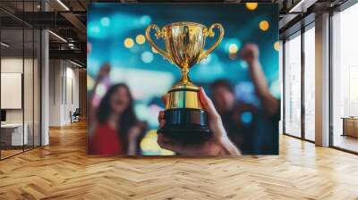 Office team celebrates with smiles and excitement, focusing on a gold trophy as a symbol of their success and accomplishment. Wall mural