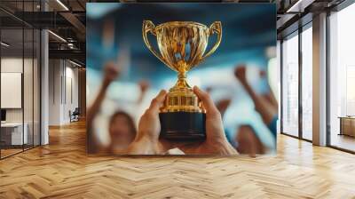 Office team celebrates with smiles and excitement, focusing on a gold trophy as a symbol of their success and accomplishment. Wall mural