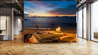 Romantic Dinner Table set beside the beach in the sunset twilight time, at Munnok Island, Thailand. Wall mural