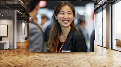 scene of friends in asian business casual attire enjoying each other's company at an exhibition boot Wall mural