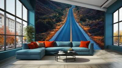 Aerial view of an endless desert highway, vast arid landscape, clear blue sky, horizon blending with the road ahead Wall mural