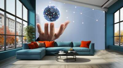 Abstract hand of businessman holding earth and global network connection and blue space background, digital network communication and partners concept Wall mural