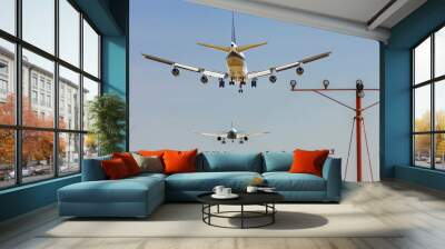 rear view of two airplanes for commercial passenger or cargo transportation to fly in sequence and spread the wheel for landings to airport on blue sky Wall mural