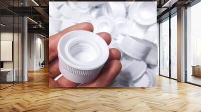 White Plastic bottle caps, made from injection molding machine. in  production department of the plastic factory. Wall mural