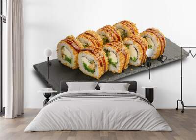 Sushi Rolls with Nishiki rice, nori, cheese, eel, seaweed salad, cucumber, sesame and Unagi sauce on black slate or stone shale surface isolated on white background. Wall mural