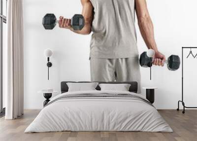 PNG studio shot of a muscular young man exercising with dumbbells. Wall mural