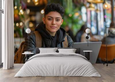 Casual portrait of a Non binary hispanic transgender mid Tomboy using laptop computer in a modern cafeteria restaurant. Androgynous authentic identity. Generative AI Wall mural