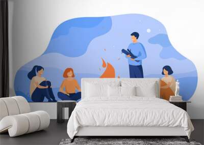 Campfire, camping, story telling concept. Cheerful people sitting at fire, telling scary stories, having fun. For summer outdoor activities or leisure time with friends topics Wall mural