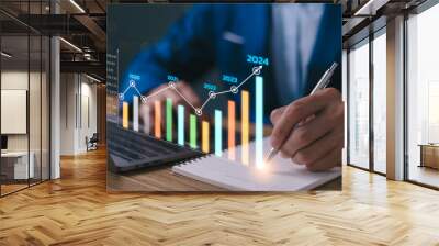 2024 business financial plan market concept, performance of profit growth on 2023 to 2024, education trend up finance on growth graph money revenue, Businessman analyzes profitability of working. Wall mural