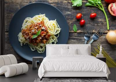 Spaghetti on black plate on wooden background. top view Wall mural