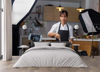 woman showing cooking in a studio Wall mural