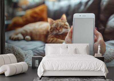 Hyber realistic photo of  Mockup image of a woman's hand holding white mobile phone with blank screen and a sleeping brown cat in background  , copy space for text, Wall mural