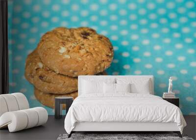 Oatmeal and raisin cookies on pastel blue polka dot background. Wall mural