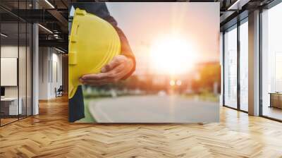 Businessman holding hard hat on site construction building estate Wall mural