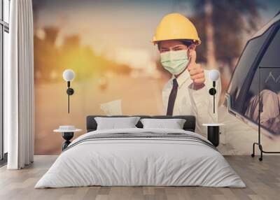 Businessman use surgical mask yellow hard hat holding blueprint inspection construction building estate Wall mural