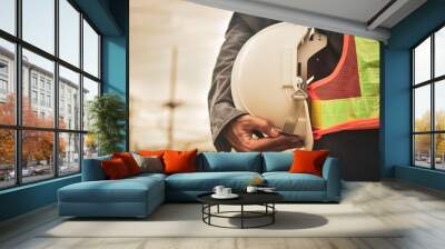 Close up hand holding white helmet hard hat Engineering concept Wall mural